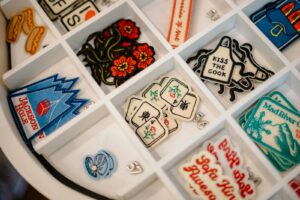 Various embroidered patches in a white organizer