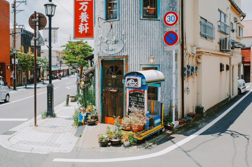 Corner building with plants and signs on street