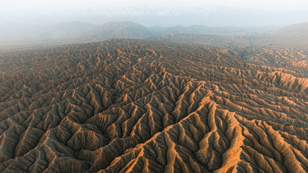 Arid desert landscape with dramatic eroded formations