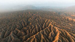 Arid desert landscape with dramatic eroded formations